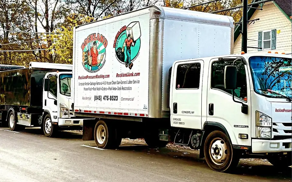 Two branded Rockland Junk Removal box trucks parked together.